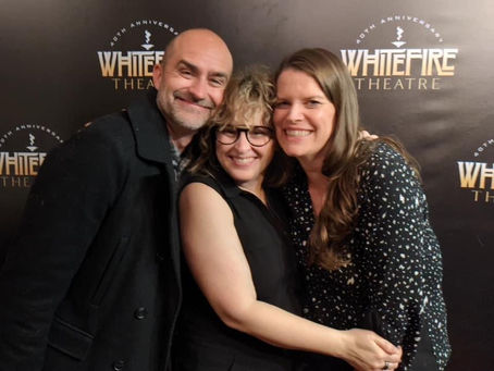 three people at Solofest photo display