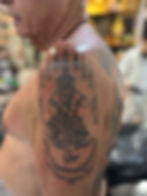 Traditional sacred Thao Vessuwan deity tattoo inked on human shoulder by Ajarn Jee in Patong Phuket