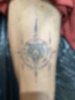 Intricate sacred tiger face sak yant tattoo with geometric scripts on human thigh by Ajarn Jee in Patong Phuket