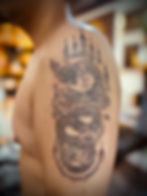 Detailed sacred Naga serpent sak yant tattoo with traditional mantras on upper arm by Ajarn Jee in Patong Phuket