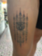 Best Sacred Sak Yant Hah Taew tattoo with bear face on human thigh by Ajarn Jee in Phuket