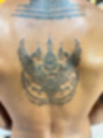 Traditional sacred Garuda Krut deity tattoo with protective mantras on human back by Ajarn Jee in Patong Phuket