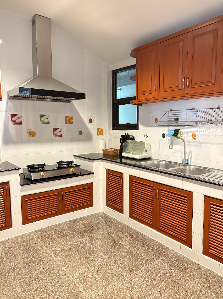 Fully equipped kitchen with a refrigerator and complete cooking essentials.