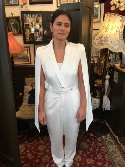 woman in white jumpsuit with open sleeves