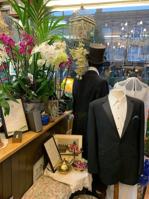 Selection of suit jackets and flowers in a display