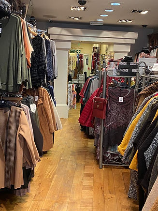 rows of full clothing racks.jpeg