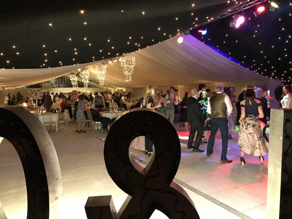 marquee full of partying wedding guests