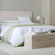 Large bed with white sheets