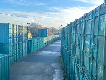 Stacks of green storage containers in a yard