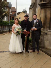 Chimney sweep posing with bride and groom