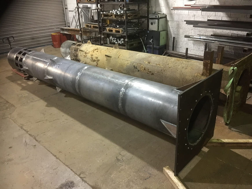 Large industrial pipe being fabricated in a workshop