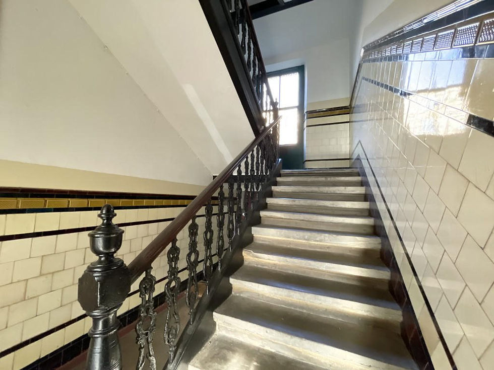 Vintage tiled stairwell with iron railing