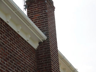 Brick chimney with guttering to the side
