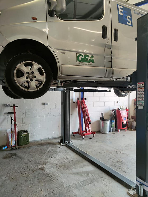 Silver van raised on a lift.jpg