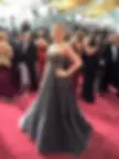 Woman in grey dress at a red carpet event