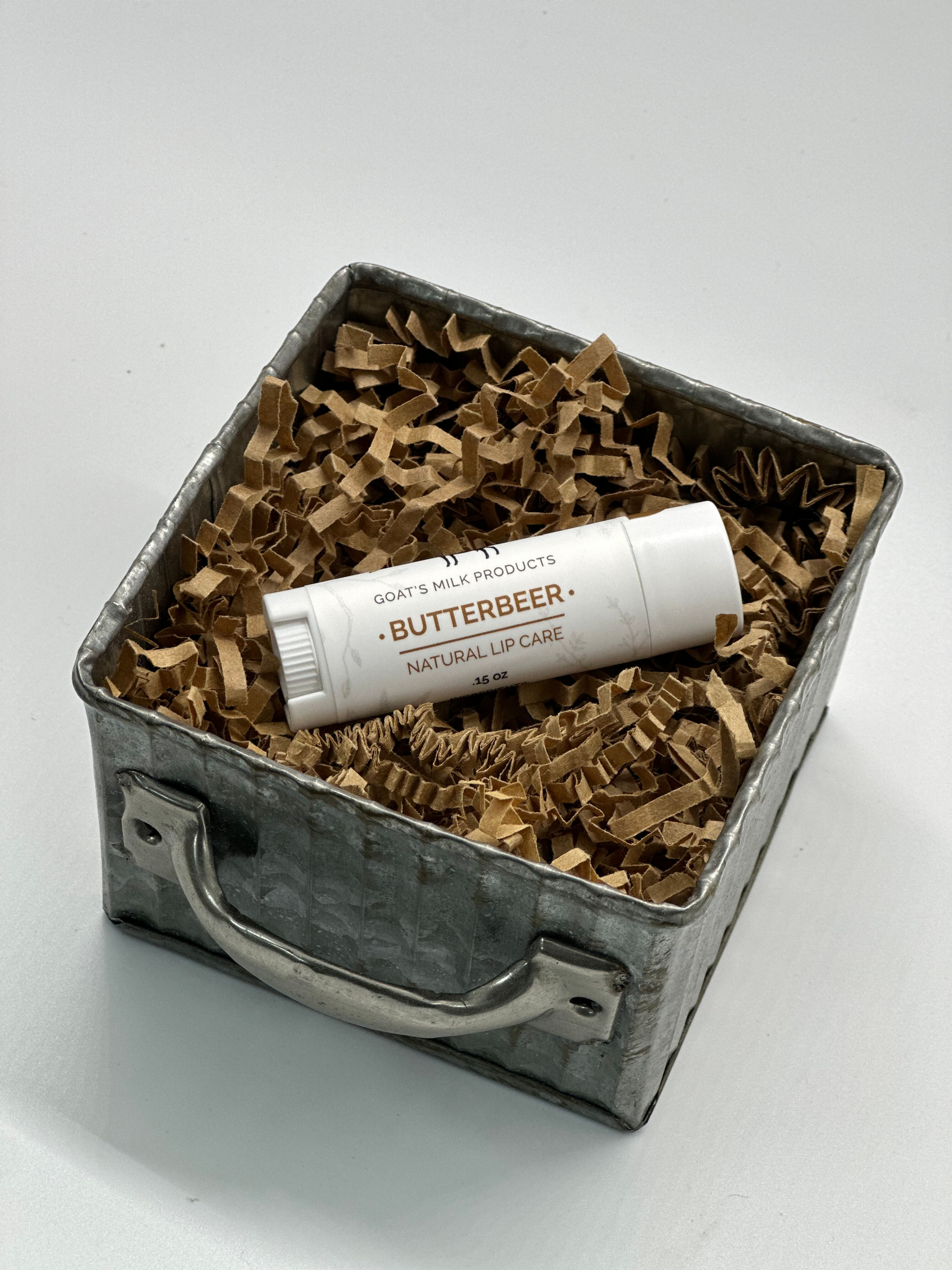 Lip balm laying in a tin bucket