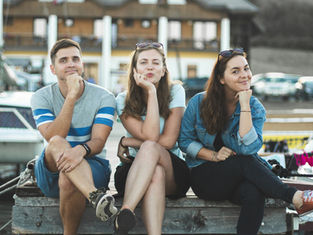 three friends sitting next to each other