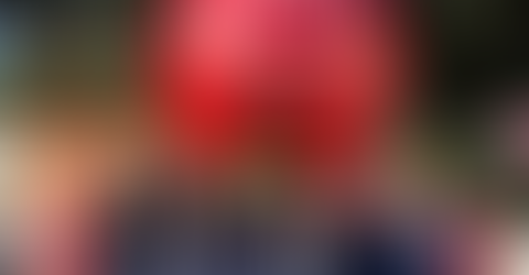 St. Victor School student council poses in front of a large Christmas in the Park ornament display in downtown San Jose.