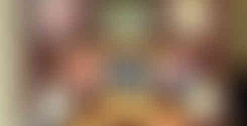 A classroom door decorated with colorful student drawings of peaches surrounding the cover of James and the Giant Peach, creating a bright, story-themed display.