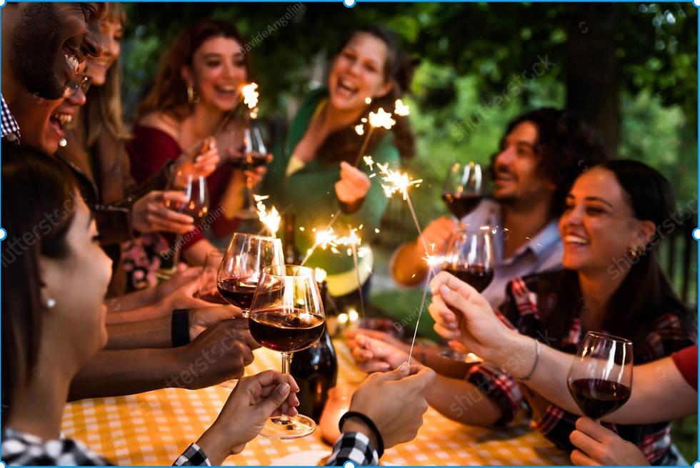 friends at picnic table with sparklers