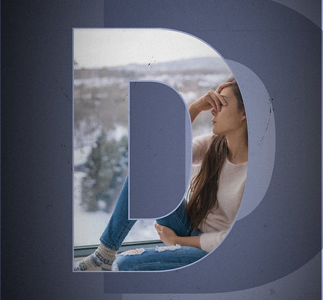 Individual feeling depressed sitting on a window seat with snow outside