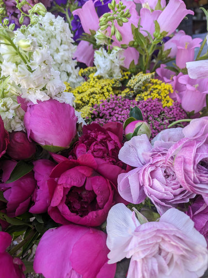 DIY bulk wedding flowers showing pink spring peonies, yarrow, and other flowers