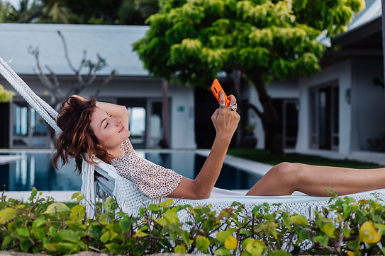 woman-with-phone-resting-lying-on-hammock-with-mobile-phone.jpg