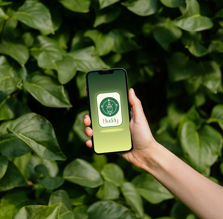 mockuuups-woman-holding-an-iphone-13-mockup-in-front-of-green-leaves.jpeg