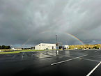 Ross Campus Building on a cloudy day with rainbow