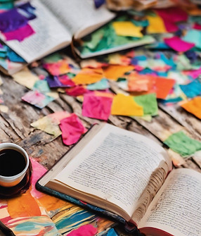 an open book with vibrant, colorful pages or a hand writing in a journal.jpg
