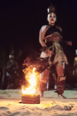 Performer running with fire in hand during a Mayan ritual on the beach in Playa del Carmen, Mexico. Photographed by lifestyle photographer Celso Marrero.