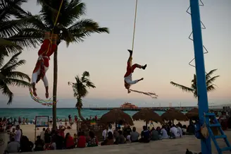 Voladores" dancers performing their traditional ceremony, descending from a high pole in Playa del Carmen, Mexico. Personal project by lifestyle photographer Celso Marrero.