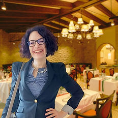 Italian Teacher Sara smiling in a restaurant setting