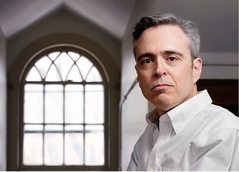 Robert Dale Parker in front of a window in his university office.