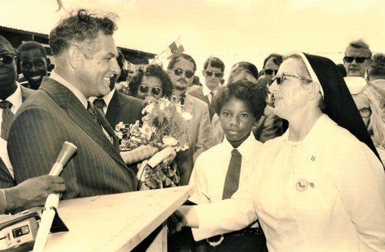 Minister Leo Chance being greeted by Sister Agatha on the opening of the pier named after him on November 8th, 1972. Will Johnson leader of the WIPM government (in dark glasses) looking on.