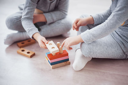 children-play-with-toy-designer-floor-children-s-room-two-kids-playing-with-colorful-block