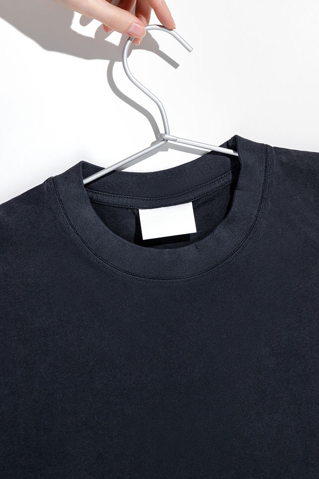 Black t-shirt with blank label on a clothes rack. Ecology concept. Mockup..jpg