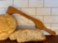 artisan bread knife propped up on homemade sliced bread