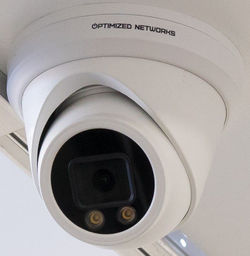 Optimized Networks branded dome security camera, close-up