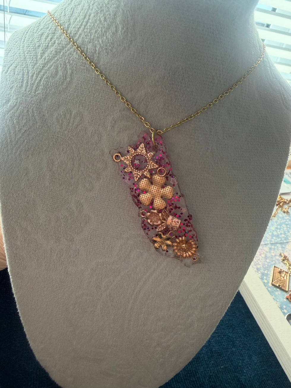 Colorful beaded flower pendant necklace on white display bust.