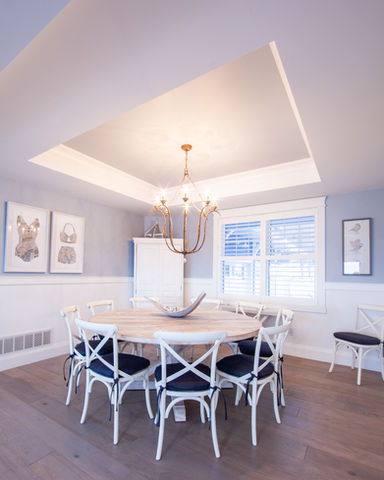 PRF Custom Built large round wooden table with pedestal and 9 white chairs and blue seat cushions with large chandelier