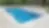 Luxury pool with seating area and landscaping, outdoor relaxation setting.
