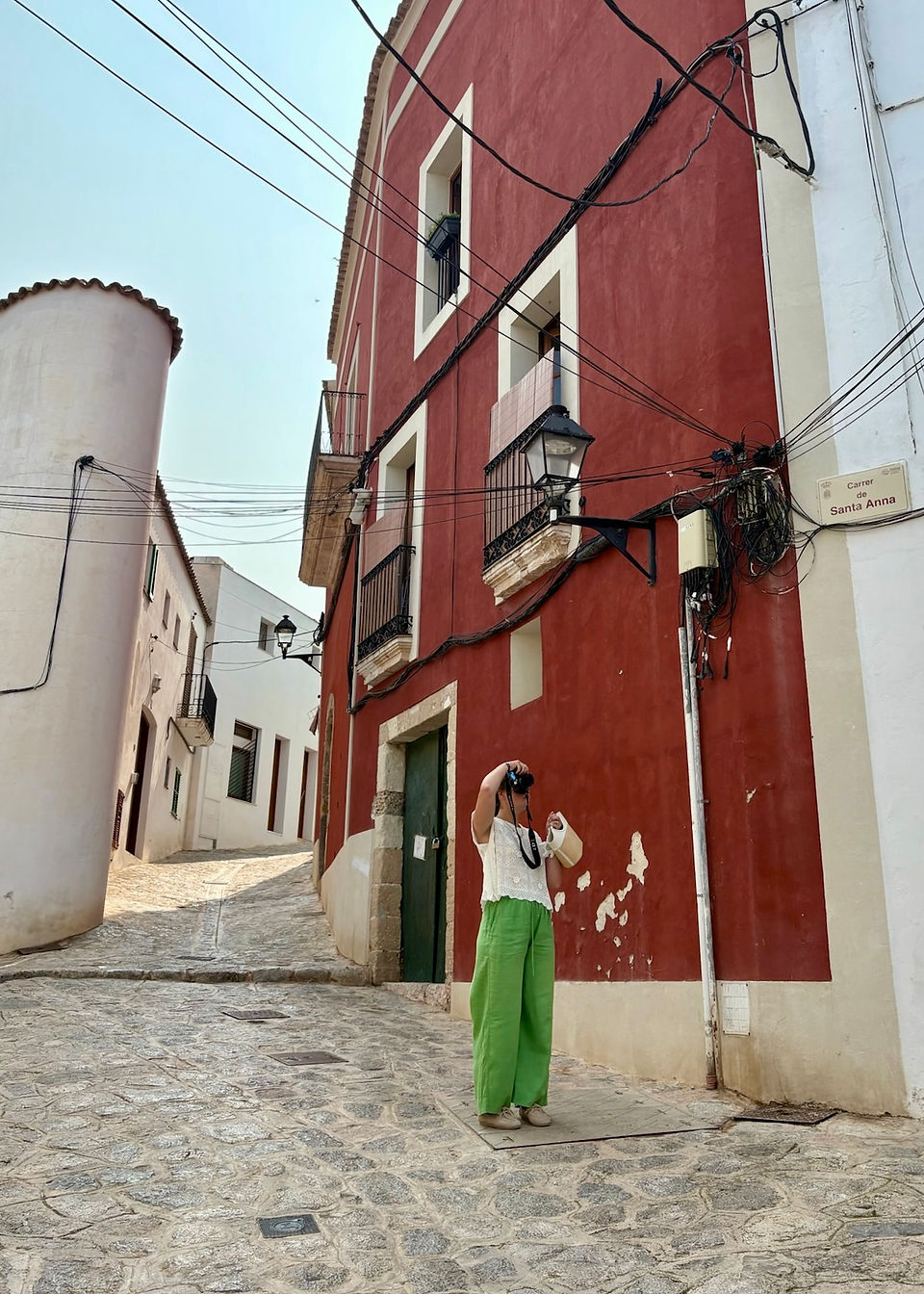 Girl making a photo through the streets of Old Town Ibiza