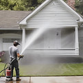 person power washing medium sized house.jpg