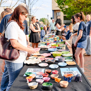 the community admiring handmade bowls