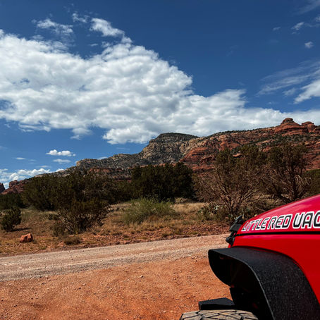 Jeep with red rocks