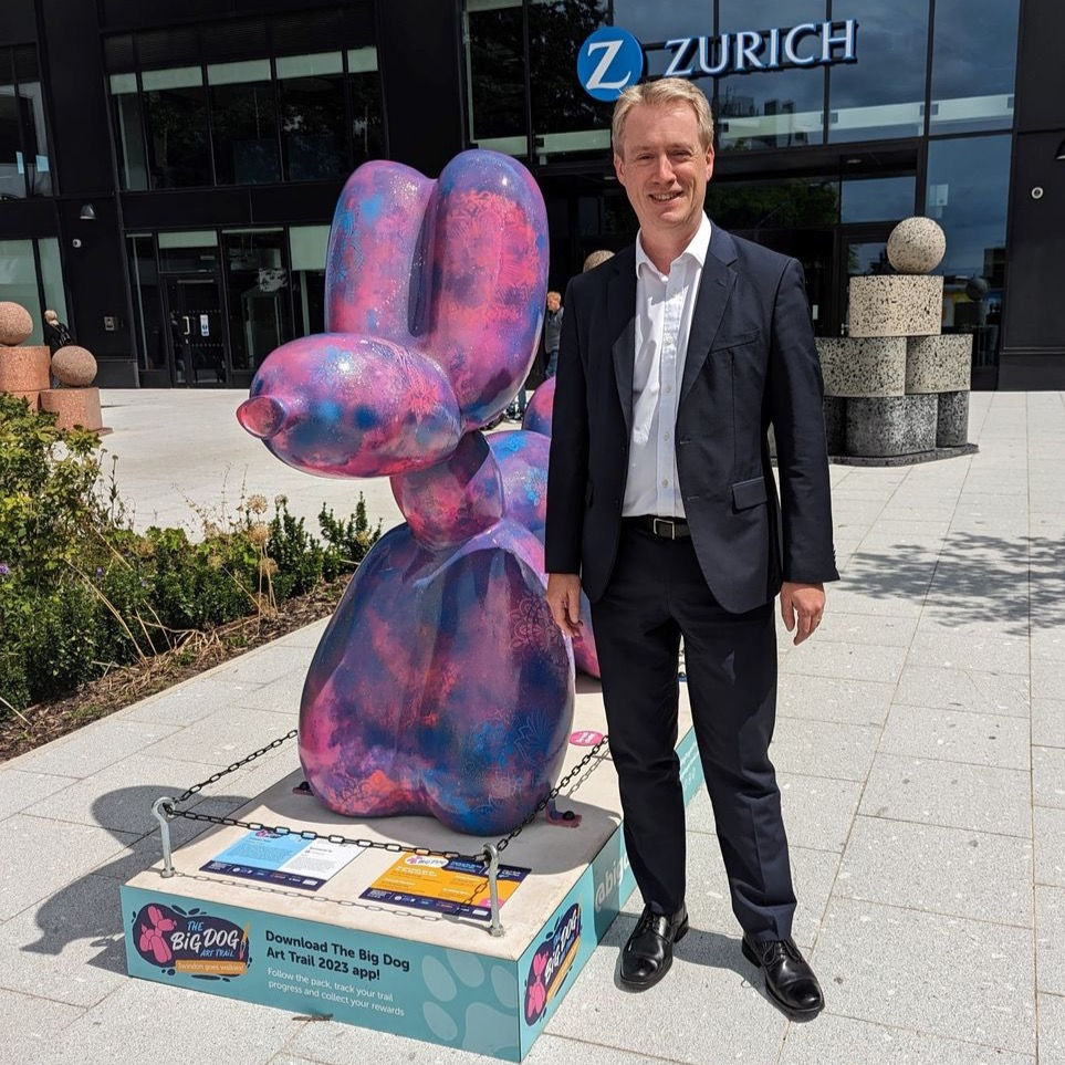 Zurich CEO, Tim Bailey with Creative Twist sculpture outside Zurich offices in Swindon