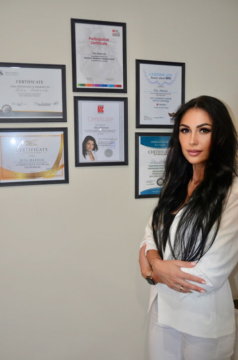 Rita Makmak with certificates