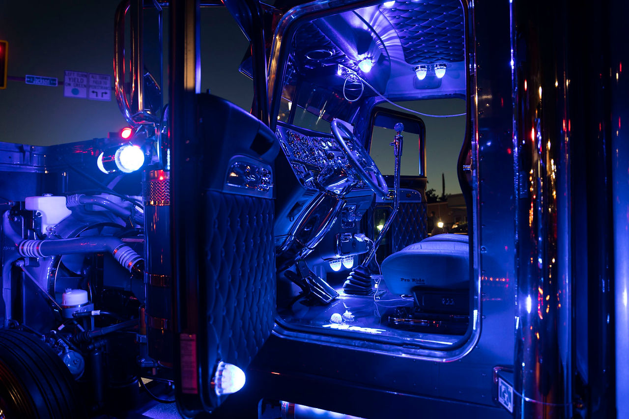 Inside of a truck with blue lights decorated all around