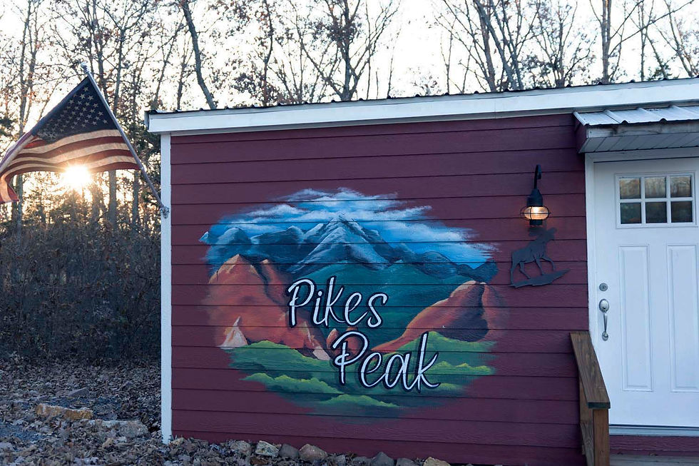 A red building with the logo of Pikes Peak painted onto it